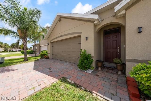 doorway to property with a garage