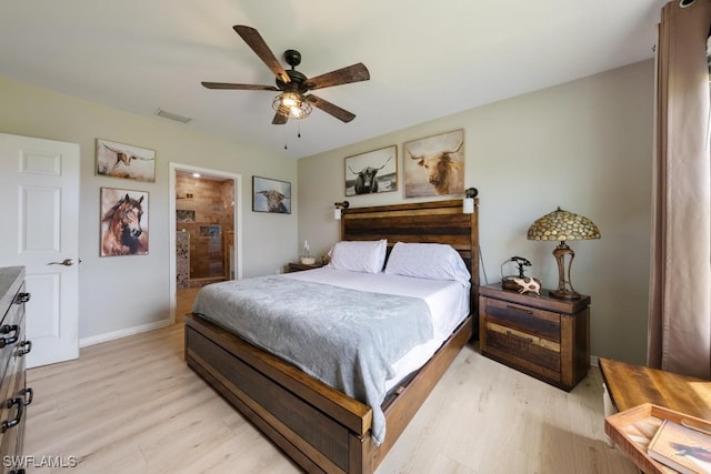 bedroom with ceiling fan, connected bathroom, and light hardwood / wood-style floors