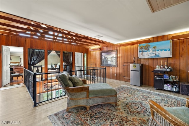 living room with light wood-type flooring and wood walls