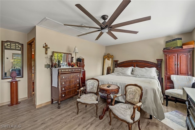 bedroom with light hardwood / wood-style floors and ceiling fan