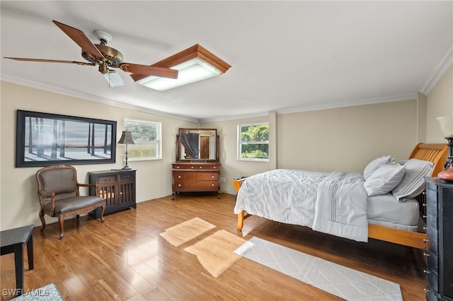 bedroom with ornamental molding, ceiling fan, and hardwood / wood-style flooring