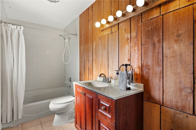 full bathroom featuring shower / bath combination with curtain, tile patterned flooring, wooden walls, vanity, and toilet