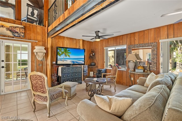 living room featuring ceiling fan, light tile patterned floors, and a wealth of natural light