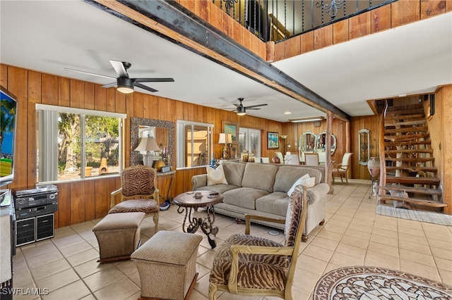 tiled living room with wood walls and ceiling fan