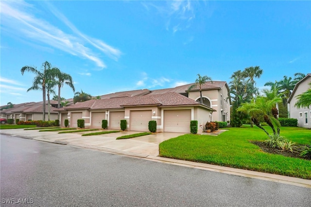 view of front facade with a front yard and a garage