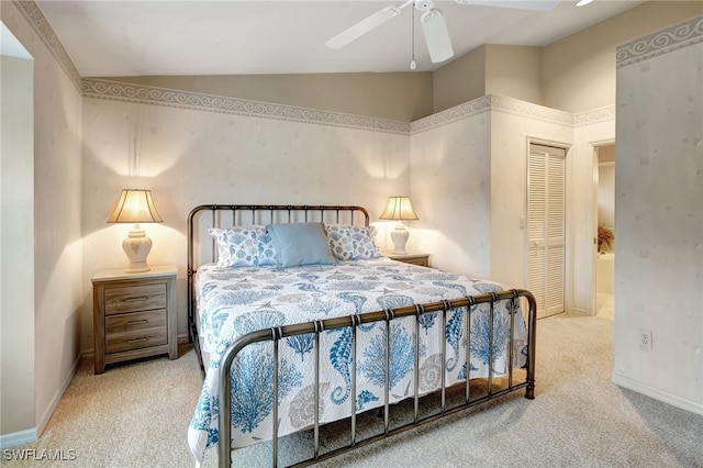 carpeted bedroom with a closet, ceiling fan, and vaulted ceiling