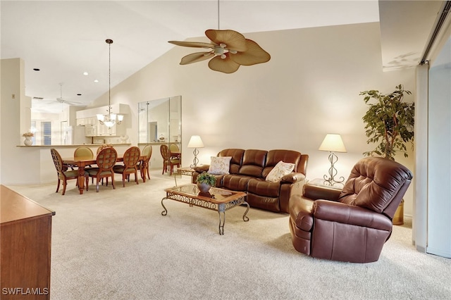 living room with light carpet, high vaulted ceiling, and ceiling fan with notable chandelier