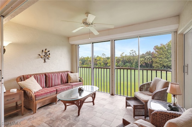 sunroom featuring ceiling fan