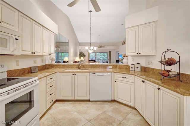 kitchen featuring lofted ceiling, kitchen peninsula, pendant lighting, light tile patterned floors, and white appliances