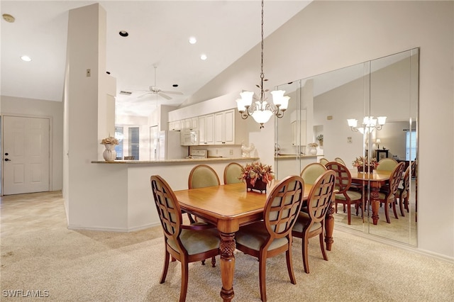 dining space with light carpet, high vaulted ceiling, and ceiling fan with notable chandelier