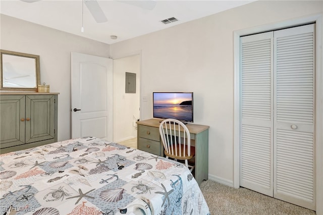 carpeted bedroom featuring a closet, electric panel, and ceiling fan