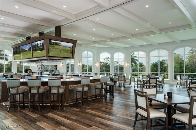 interior space featuring coffered ceiling, beam ceiling, and a healthy amount of sunlight