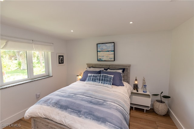 bedroom with hardwood / wood-style flooring