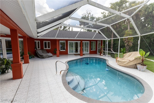 view of swimming pool featuring a lanai and a patio area