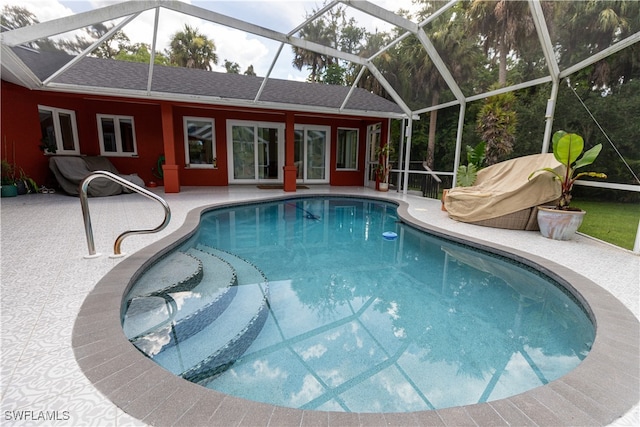 view of pool with a patio and a lanai