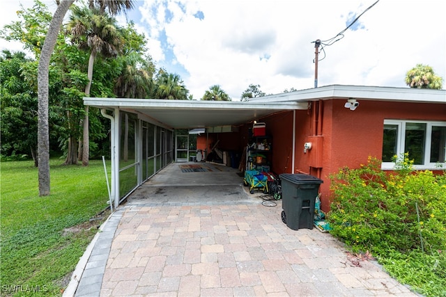 view of parking / parking lot with a lawn and a carport