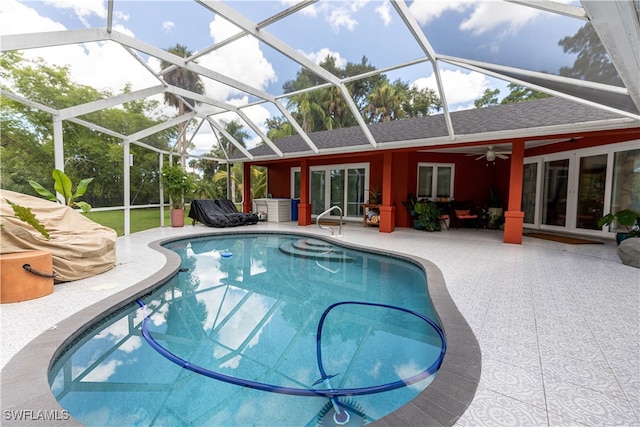 view of pool featuring ceiling fan, french doors, glass enclosure, and a patio