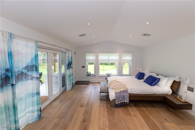 bedroom featuring light wood-type flooring, vaulted ceiling, and access to exterior