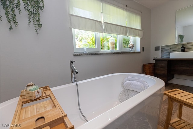 bathroom with a bath and vanity