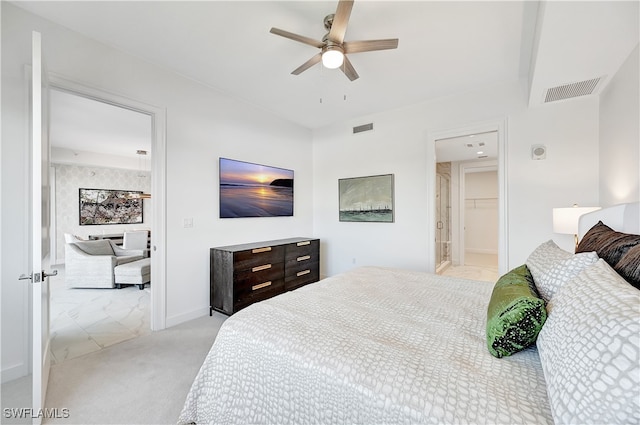 bedroom featuring ensuite bath, ceiling fan, and light colored carpet