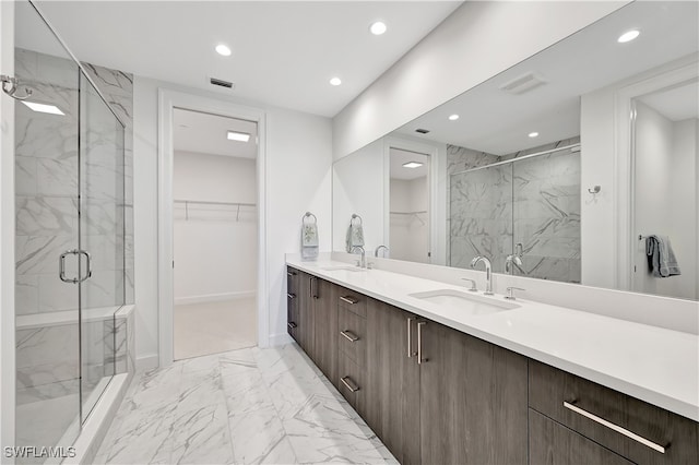 bathroom featuring vanity and a shower with door