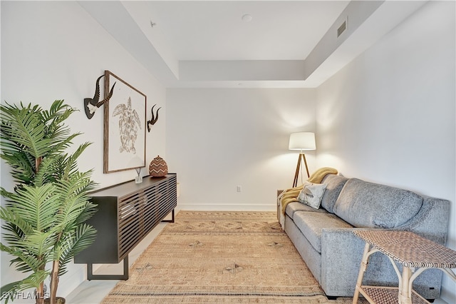 living room featuring a tray ceiling