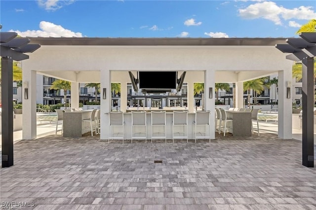 view of home's community featuring a pergola and exterior bar