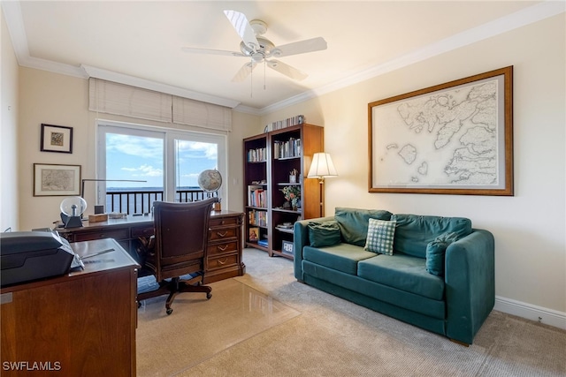 carpeted home office featuring ceiling fan and ornamental molding