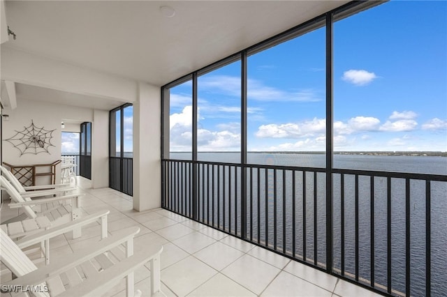 unfurnished sunroom with a water view