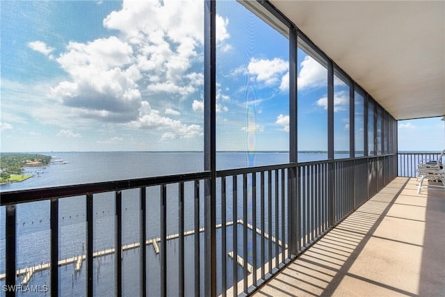 unfurnished sunroom with a water view