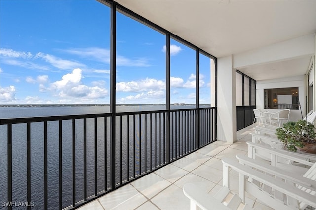 unfurnished sunroom with a water view