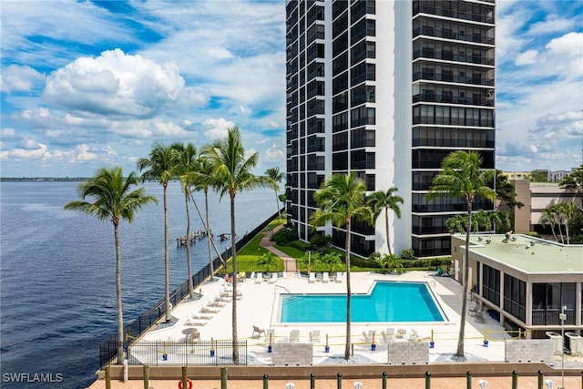 view of pool featuring a water view and a patio