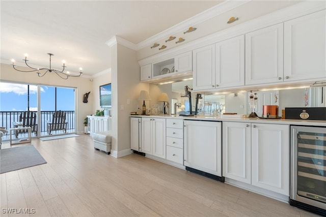 kitchen featuring wine cooler, ornamental molding, white fridge, light hardwood / wood-style floors, and white cabinetry