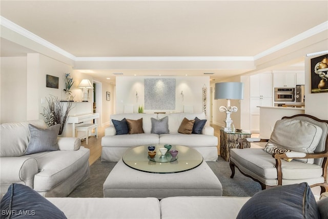 living room with wood-type flooring and crown molding