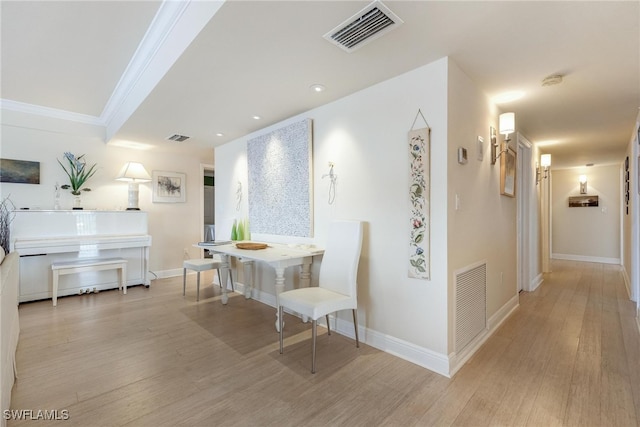 hall featuring light hardwood / wood-style floors and ornamental molding