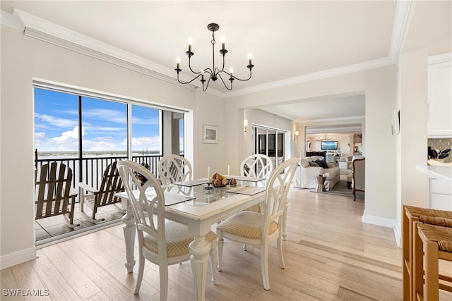 dining room with an inviting chandelier, ornamental molding, and light wood-type flooring