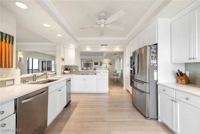 kitchen featuring decorative backsplash, white cabinets, light hardwood / wood-style floors, and appliances with stainless steel finishes