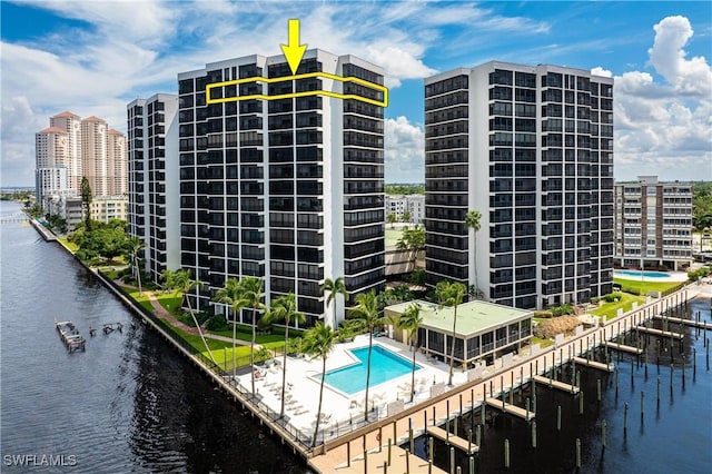 view of property featuring a water view and a community pool