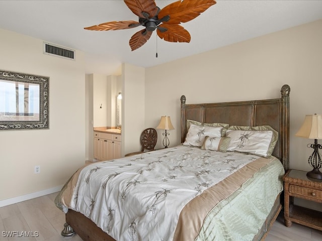 bedroom featuring connected bathroom, light hardwood / wood-style floors, and ceiling fan