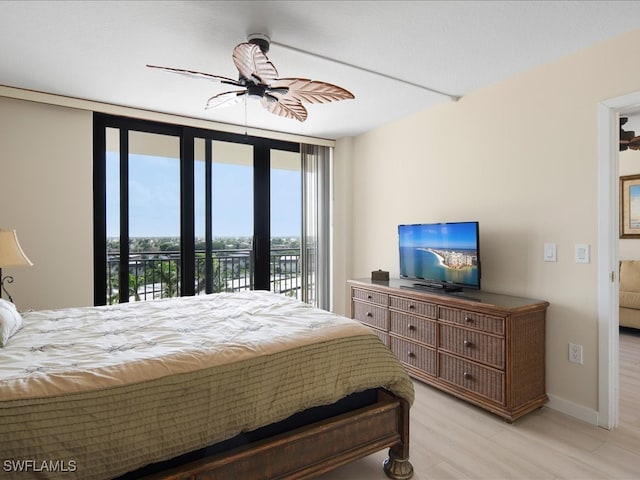 bedroom featuring floor to ceiling windows, light hardwood / wood-style floors, access to exterior, and ceiling fan