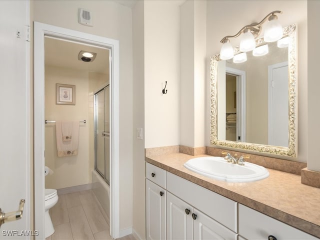 full bathroom with combined bath / shower with glass door, vanity, and toilet