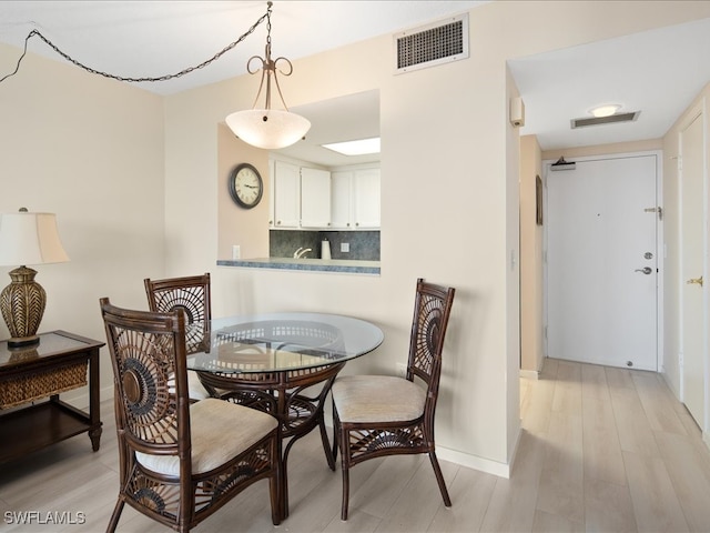 dining area with light hardwood / wood-style flooring