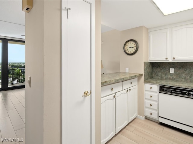 kitchen featuring light wood-type flooring, backsplash, white cabinetry, and dishwasher