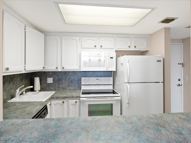 kitchen with white cabinets, backsplash, sink, and white appliances