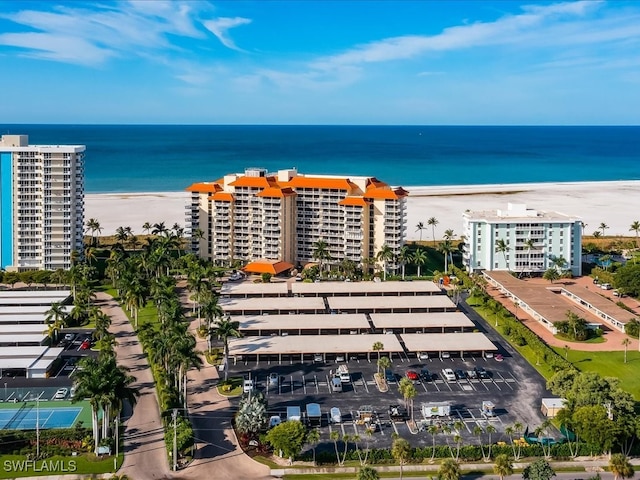 drone / aerial view featuring a water view and a beach view