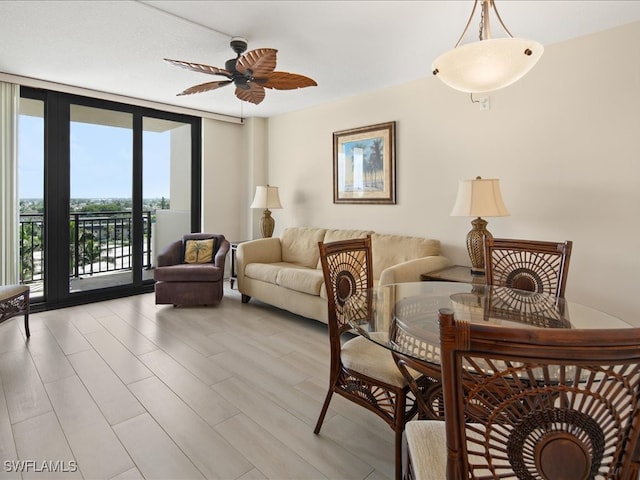 interior space featuring light wood-type flooring, ceiling fan, and floor to ceiling windows