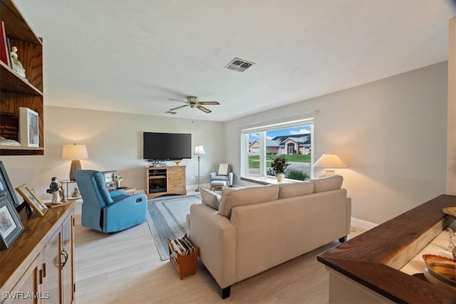 living room featuring ceiling fan and light hardwood / wood-style floors