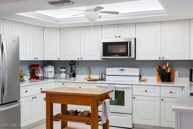 kitchen featuring ceiling fan, stainless steel appliances, and white cabinets