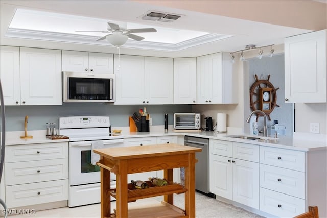 kitchen with white cabinetry, sink, ceiling fan, and stainless steel appliances