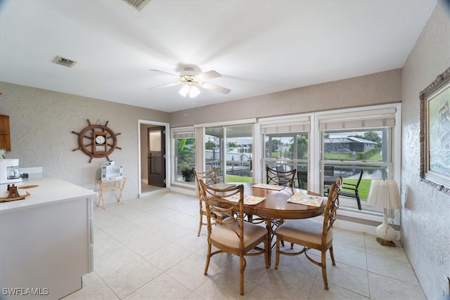 tiled dining area with ceiling fan